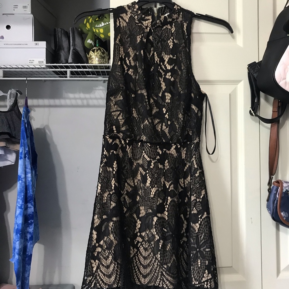 A tan halter dress with black lace